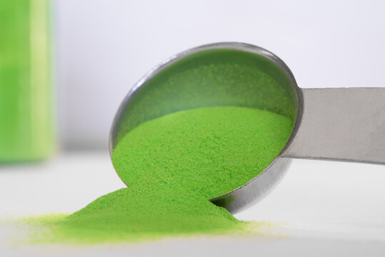 Green Powdered Food Coloring Spilled from a Teaspoon