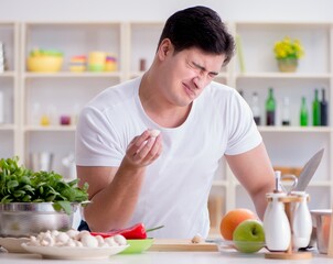 Young male cook working in the kitchen