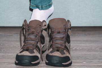 close-up. The foot in boot. A man pulls a shoe out of the box.