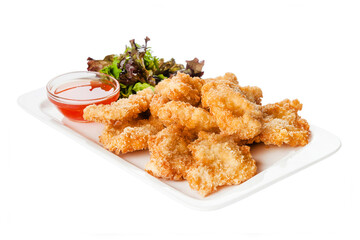 Side view of fried chicken fillet in panko breadcrumbs served with lettuce. sweet and sour sauce in saucepan near dish isolated on white background 
