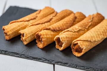 Wafer rolls with condensed milk. Thin and Crispy Waffle. Selective focus