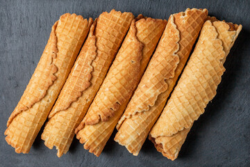 Wafer rolls with condensed milk. Thin and Crispy Waffle. Selective focus