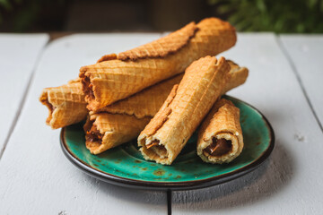 Wafer rolls with condensed milk. Thin and Crispy Waffle. Selective focus