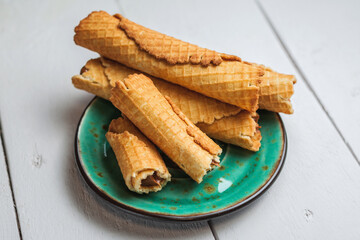 Wafer rolls with condensed milk. Thin and Crispy Waffle. Selective focus