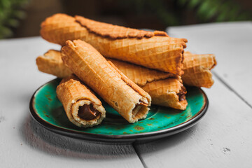 Wafer rolls with condensed milk. Thin and Crispy Waffle. Selective focus