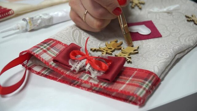 Christmas flat lay of winter decorations and sweets: diy for making boots as a gift for Christmas and New Year. girl decorates christmas boot