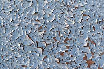 Surface with old backdrop paint. Color - Link Water, Hue Blue. Paint cracking, peeling, shadows.