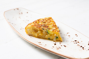 Spanish omelette cooked with potato and zucchini. Typical recipe from the central area of ​​Spain.