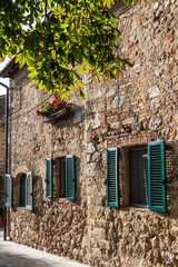 Typical Tuscan villages with their stone houses and green shutters and their flowery gardens