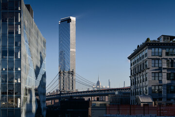 Naklejka premium New York, USA - 2021: One Manhattan Square skyscraper residential building photographed from Brooklyn Bridge. One of the tallest buildings from America. Lower east side apartments.