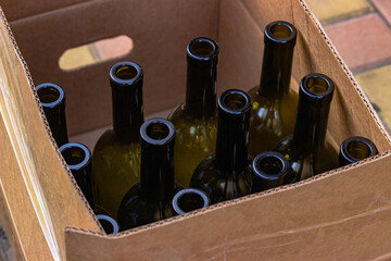 
Cardboard box with empty wine bottles prepared for bottling