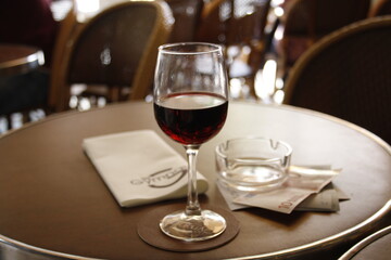 a glass of red wine at sunset in paris