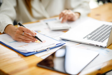 Businesswoman working at office with documents on his desk, doing planning analyzing the financial report, business plan investment, finance analysis concept