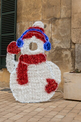 Close-up of an urban Christmas decoration, where you can take a picture with a snowman costume