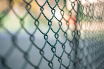 Close-up chain link fence , Sunset background