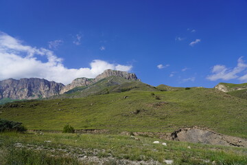Landscape with sky and clouds. Rocks and hills