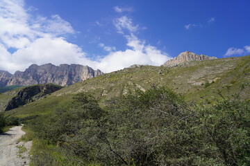 Landscape with sky and clouds. Rocks and hills