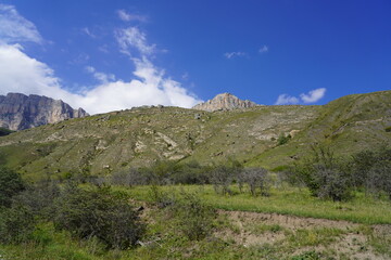 Landscape with sky and clouds. Rocks and hills