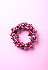 Christmas Wreath on bright paper background. Top view. Copy space. 