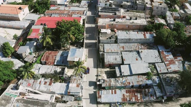 Urban landscape with dysfunctional quarters. Rusty roofs of dilapidated buildings. Lack of infrastructure and social inequality. Poor and dirty areas of the capital.