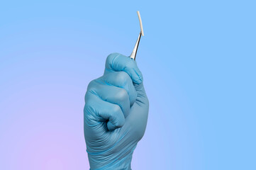 hand holding a hormonal implant with tweezers