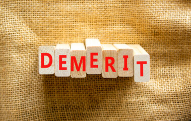 Demerit symbol. The concept word Demerit on wooden blocks. Beautiful canvas background, copy space....