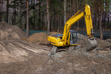 Excavator working on a construction site in the countryside