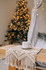 cup of coffee on the background of the Christmas tree vertical photo