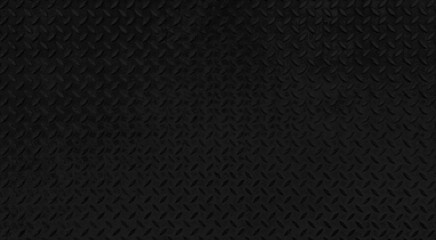 dark black steel checkered plate texture and background. black with rhombus shapes for industrial...