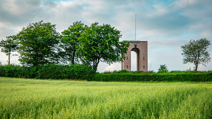 Fototapeta na wymiar Landscape of green grass field, trees and tower. Denmark highest point, Ejer Bavnehoj.