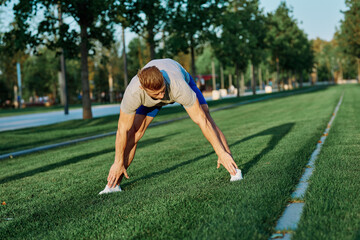 sporty man in the park on the lawn exercise lifestyle