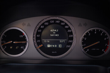 Speedometer scoring speed. Luxury business Car Dashboard Instruments illuminated at night. Rev counter. Modern Vehicle cluster. Car cluster revs. Diesel car with auto gearbox