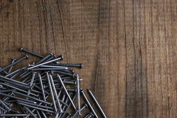 Close up of carpentry nails. Nails on a wooden background.