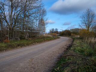 wet gravel road with water in countryside
