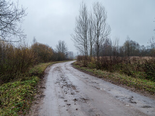 wet gravel road with water in countryside