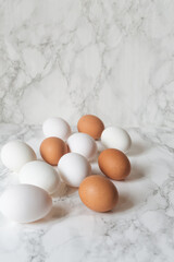 Close up  chicken white and brown eggs in a  blue bowl.  chicken eggs on the table. Farm products, natural eggs.