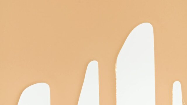 Foundation for face, smear, concealer, cosmetic liquid foundation, or cream beige color smudge flowing down on a white surface. Beauty skincare sample. Macro Shot. High quality 4k footage
