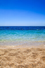The view of beach, clear sea and blue sky in Greece