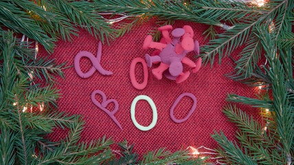 On a Christmas festive background, there are letters, symbols of different strains of coronavirus....