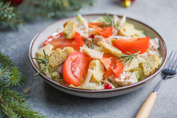 Christmas salad. Chicken Cesar salad with croutons, grated cheese , tomato