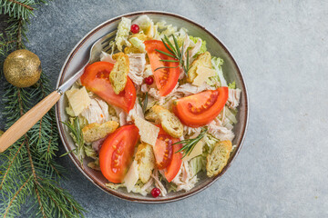 Christmas salad. Chicken Cesar salad with croutons, grated cheese , tomato