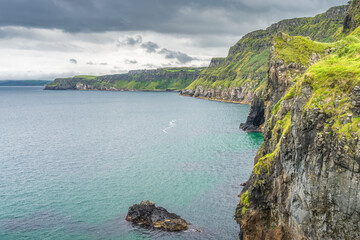 Fototapeta na wymiar Coastline with tall limestone cliffs, Rathlin Island and turquoise Atlantic Ocean near Carrick a Rede rope bridge, Wild Atlantic Way, Northern Ireland