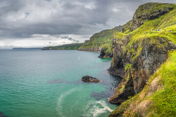 Coastline with tall limestone cliffs, Rathlin Island and turquoise Atlantic Ocean near Carrick a...