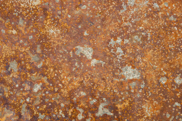 Corrosion. Metal plate with weathered colors and rust. Orange metal plate. Old oxidized colorful textured surface. Abstract grunge rusty metallic background for multiple uses.