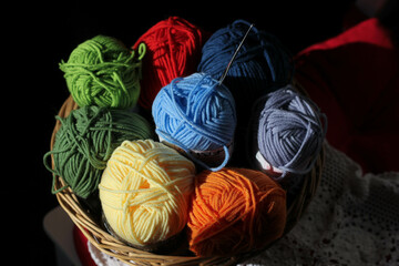 Fototapeta na wymiar multicolored balls of thread for knitting in a basket 