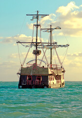 Old pirate style ship at golden sun light in the Caribbean, Punta Cana, Dominican Republic