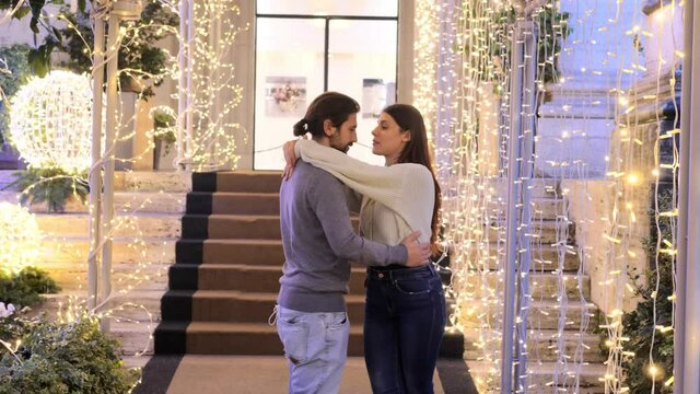 slow motion on young couple improvising dance steps in the street among the christmas decorations