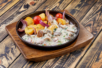 Rustic style fried pork with potatoes and mushrooms