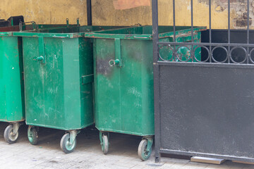 Garbage containers in the courtyard. The reverse side of the old building.