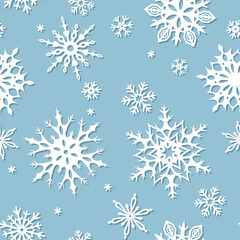 Vector seamless winter pattern with white snowflakes on a blue background. Christmas ornament. 